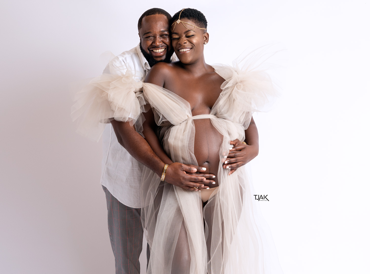 husband and wife pregnancy photoshoot in a tulle maternity dress