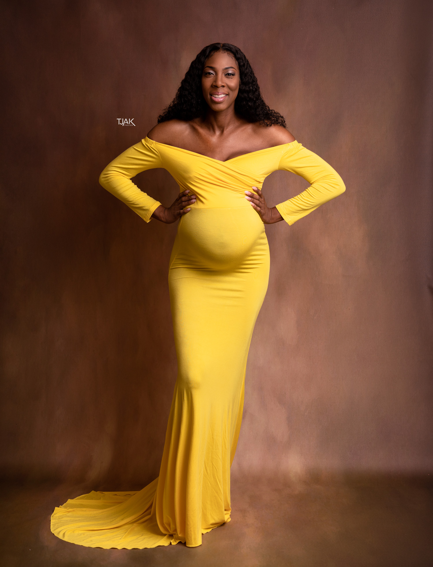 studio pregnancy photoshoot of a pregnant woman in yellow maternity dress in a studio near Baltimore Maryland