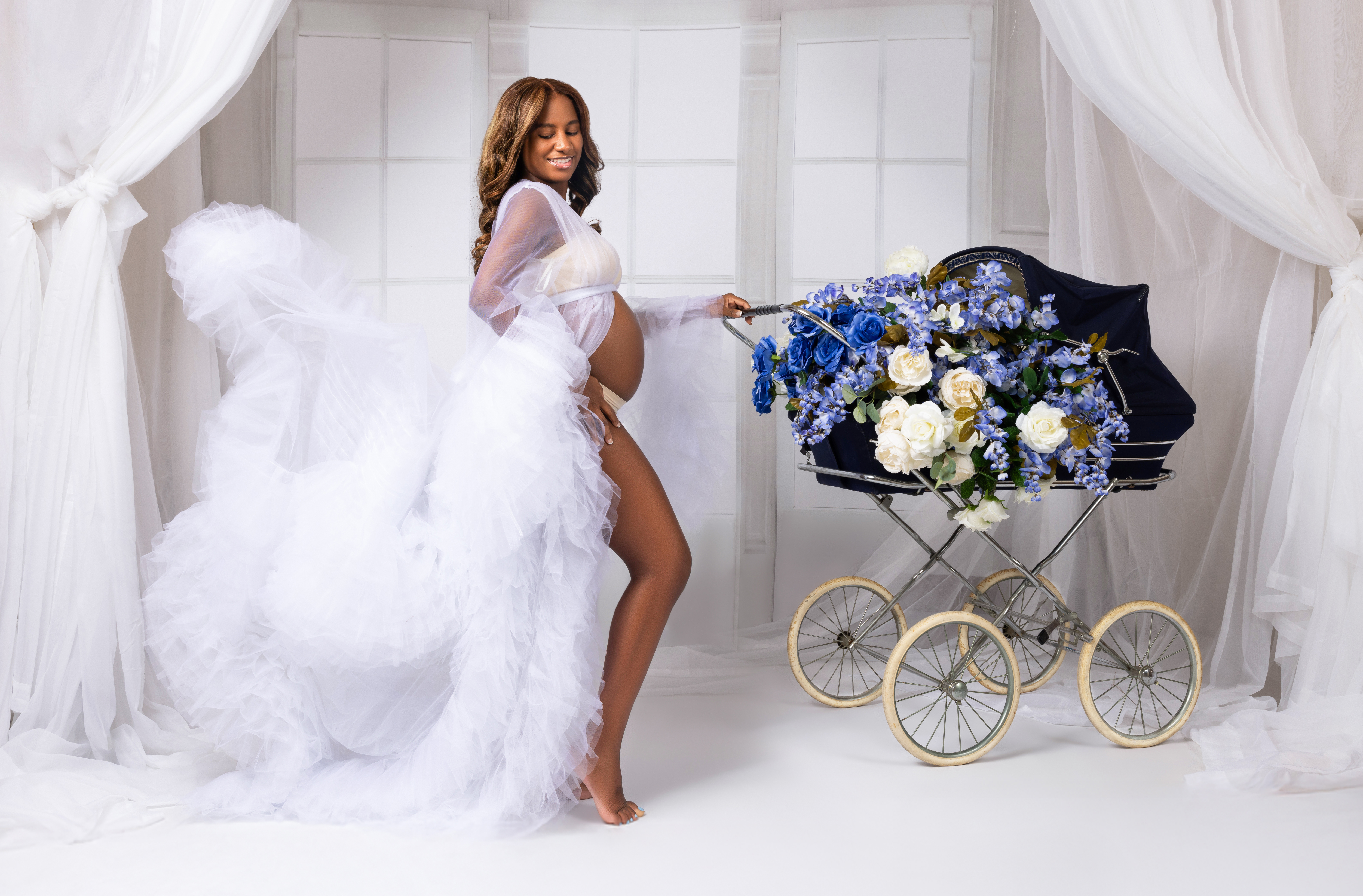 All white maternity photoshoot with vintage carriage
